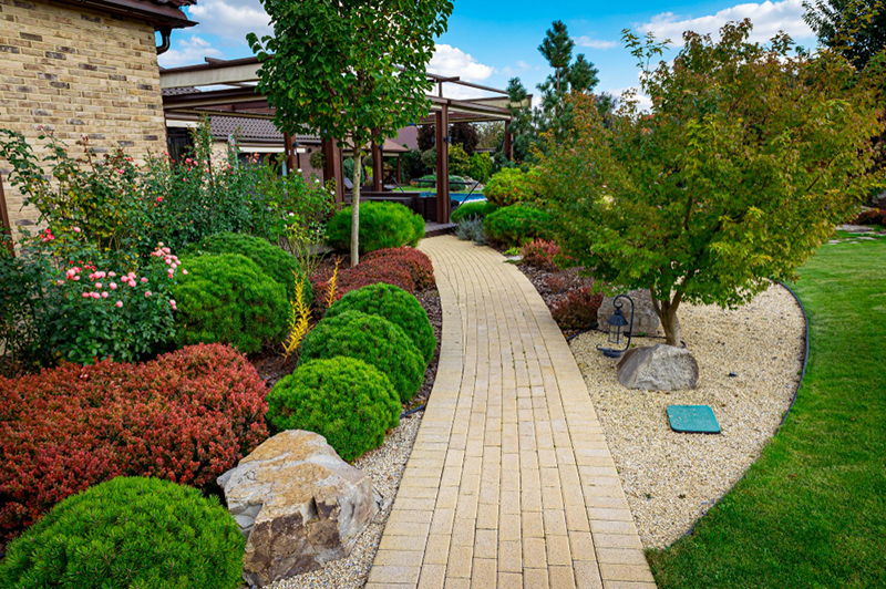 a beautiful pathpway to a home backyard showing hardscaping features